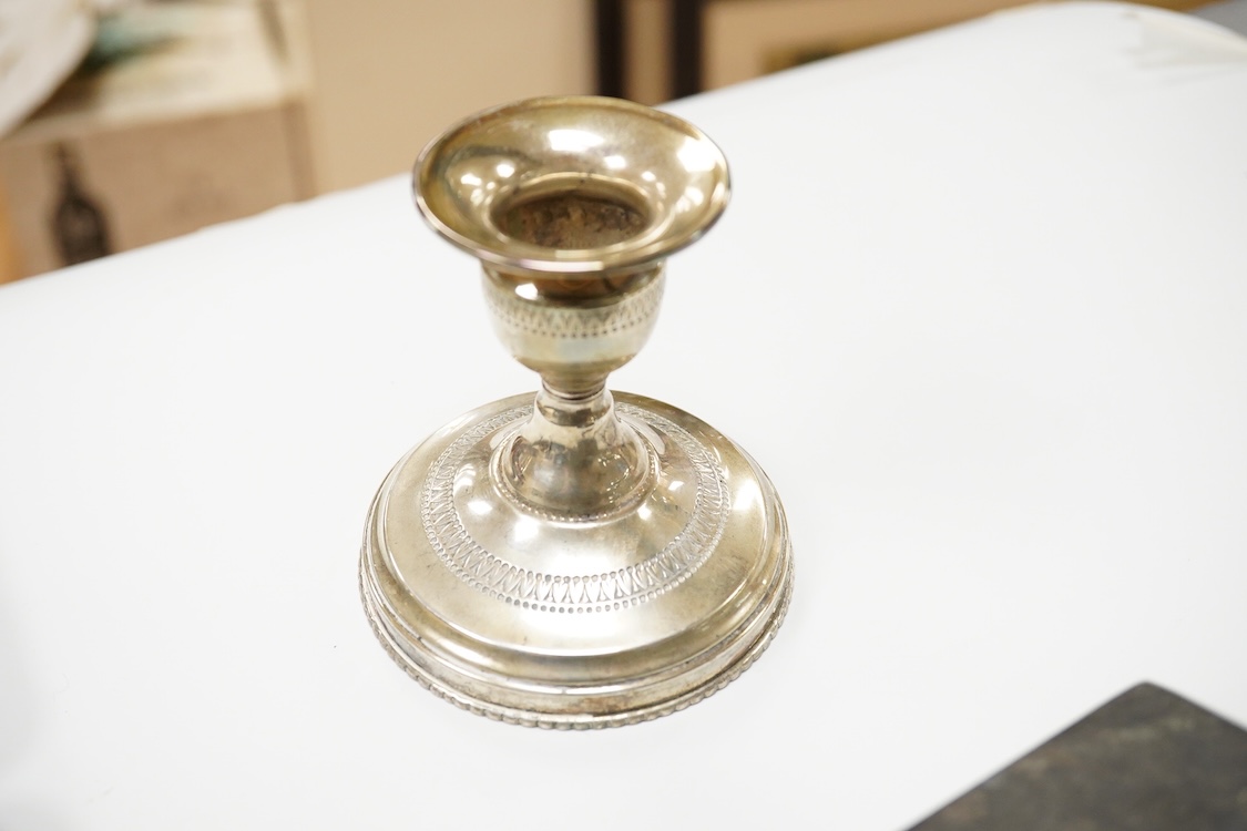A collection of silver and white metal items, to include a cigarette box, a/f, a German dwarf candlestick, a cased spoon and pusher, etc.